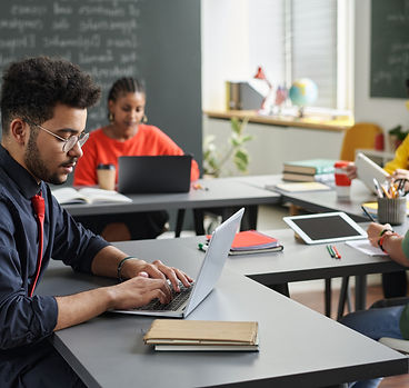 male-teacher-using-laptop-side-view.jpg