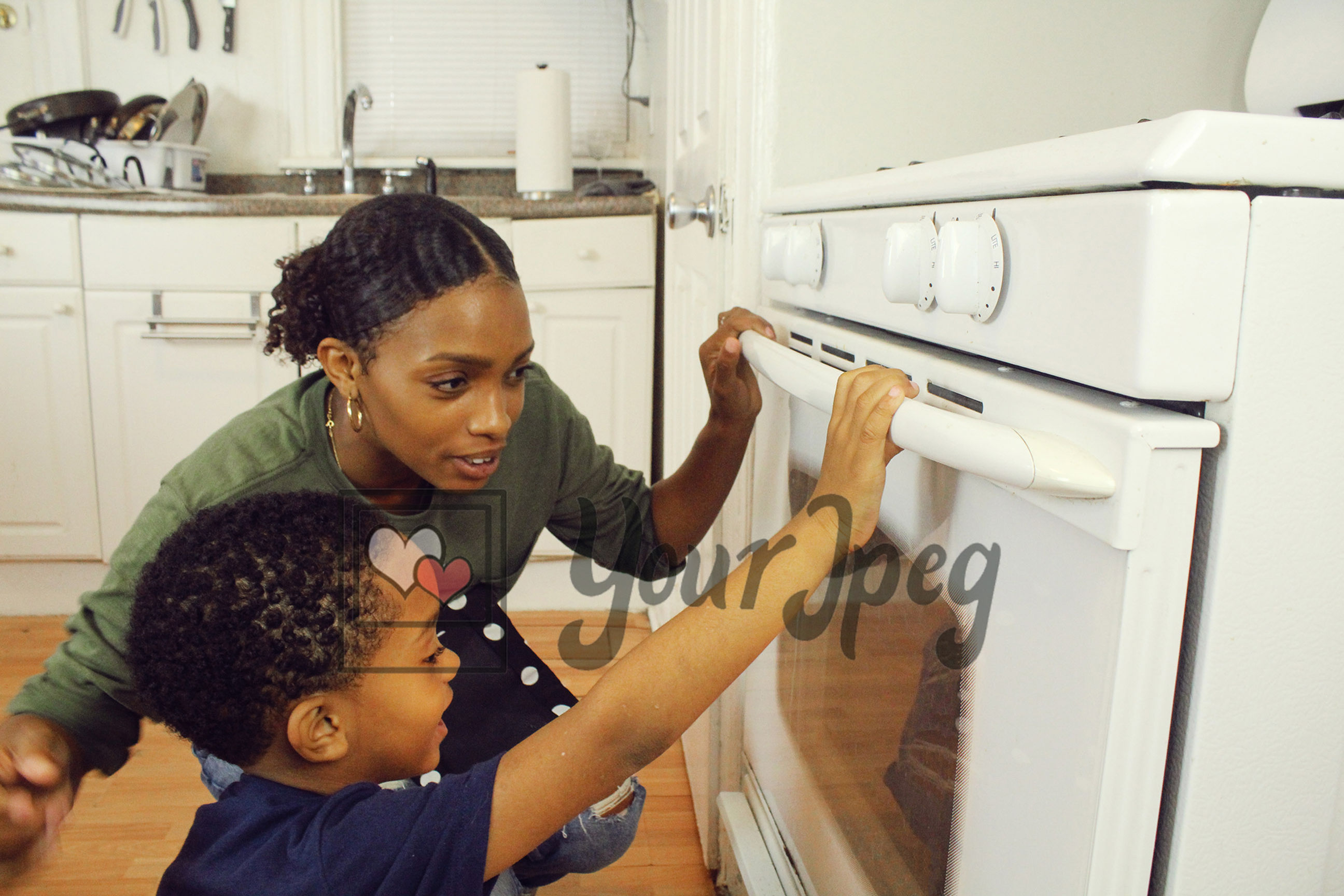 Mom and son looking in oven 1
