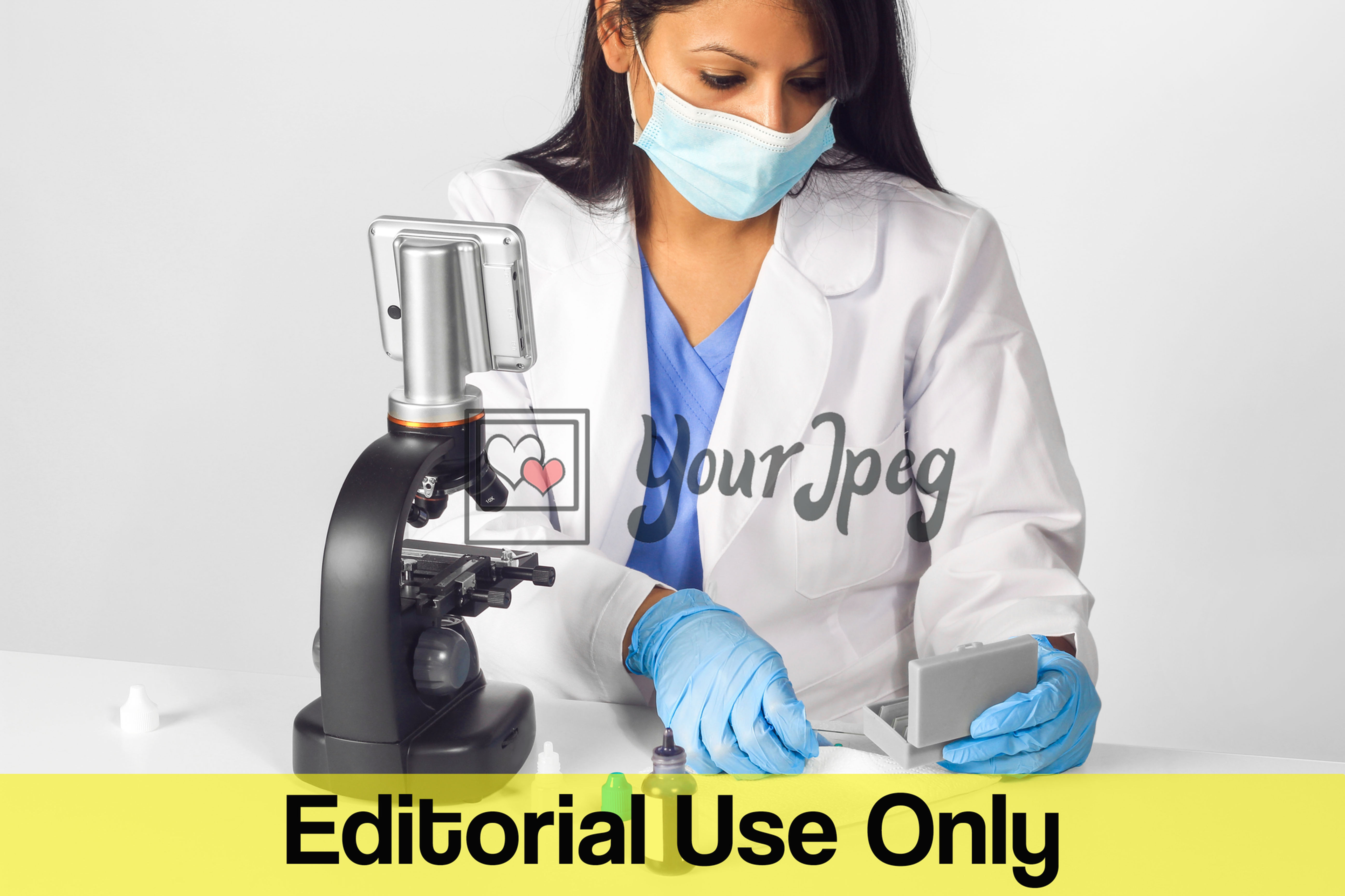 Female Doctor Wearing Mask And Gloves While Using Microscope Equipment #1