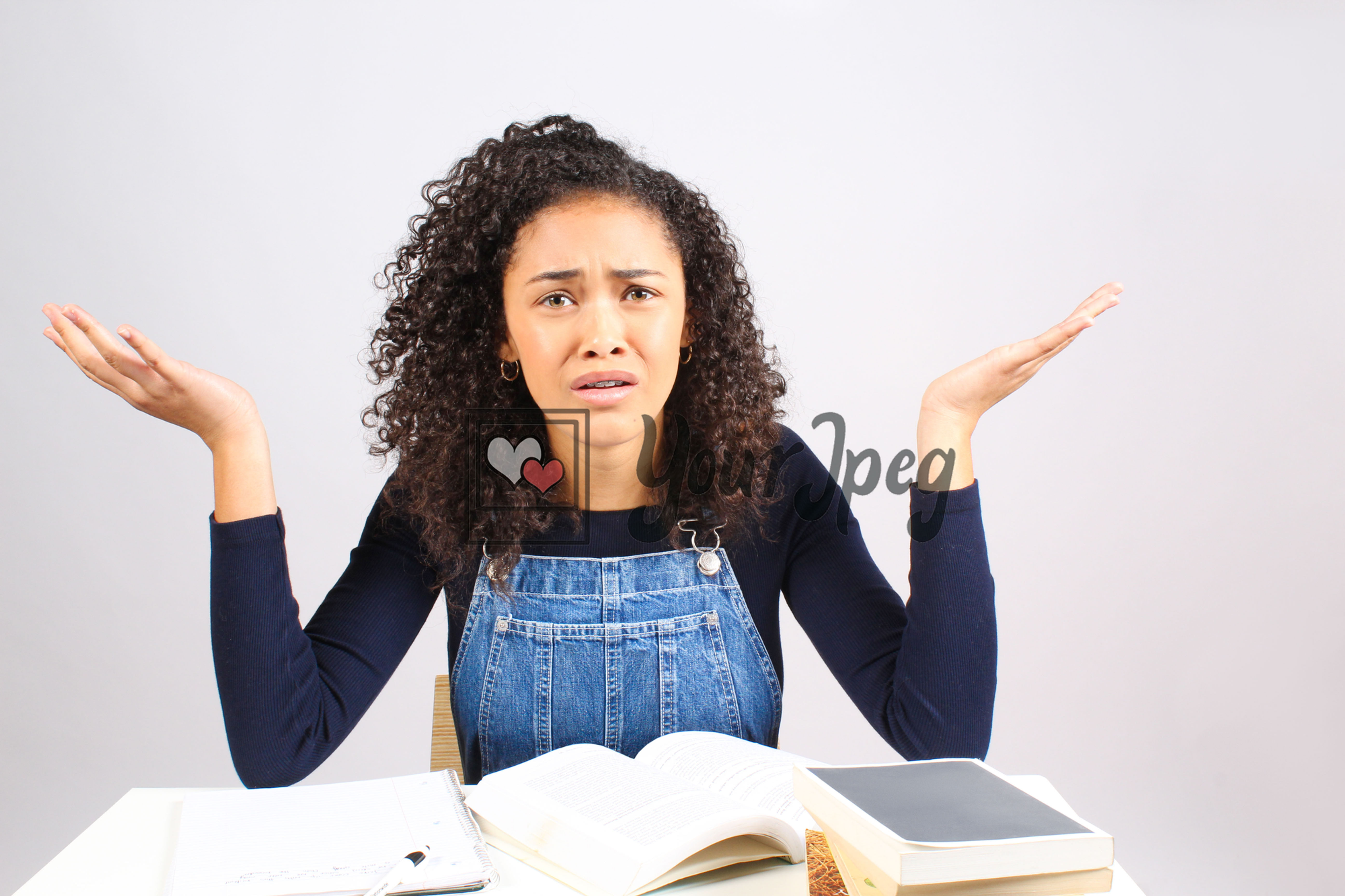 Teen girl studying confused