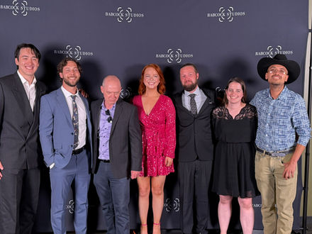 Cast members pose together on the red carpet during the Babcock Studios Summer Film Festival before screenings of original student films and award presentations.