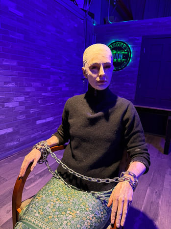 Actor seated in character during a Bugonia scene at Babcock Studios