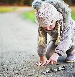 little-girl-counts-stones-on-a-road-PQ3HJ2R (1).jpg