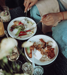 Woman enjoys delicious food at the Aurora Rooftop Bar.
