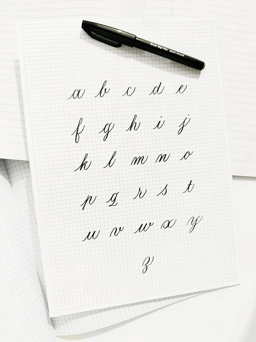 Een gekalligrafeerd alfabet en een brushpen