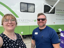 Starting Point staff members smiling in front of the Mobile Mental Health Clinic