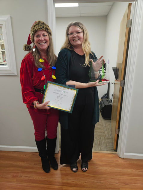 Starting Point CEO dressed up as Santa Claus delivering goodies to staff members.