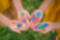 Image of four hand sholding puzzle pieces