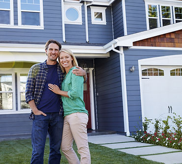 Portrait Of Couple Standing Outside House.jpg
