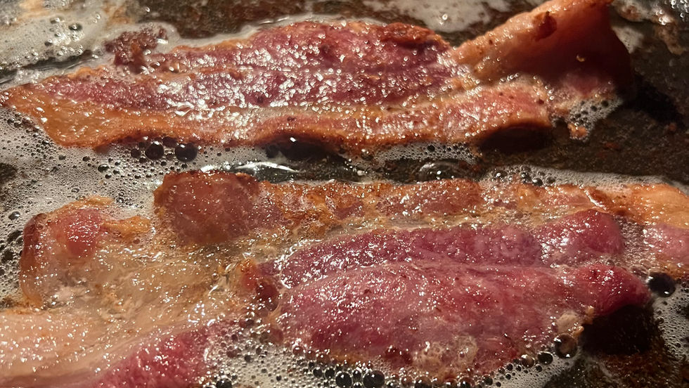 Bacon sizzling in a pan, feature image for a Daily Musing by Maricelia Sanchez