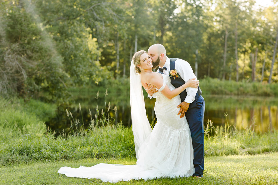 Groom kissing his new Bride at the waterfront venue in Beaverdam, Virginia