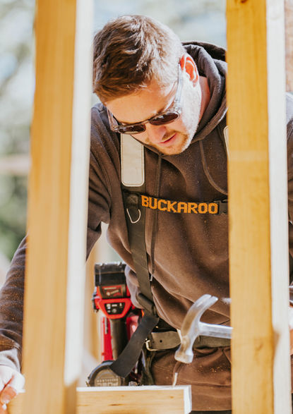 Backman Builders carpenter focused on timber work onsite.