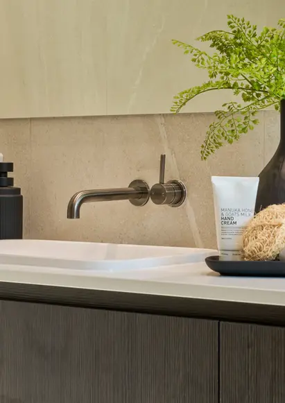 Contemporary luxury powder room with wall-mounted tapware and minimal decor.