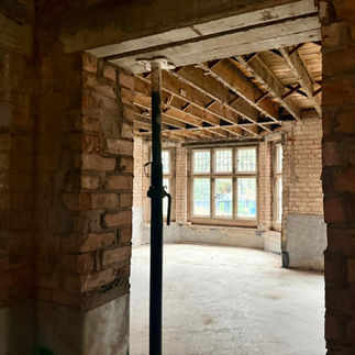 View through Littleover Hall as the space is opened up, large stone window.
