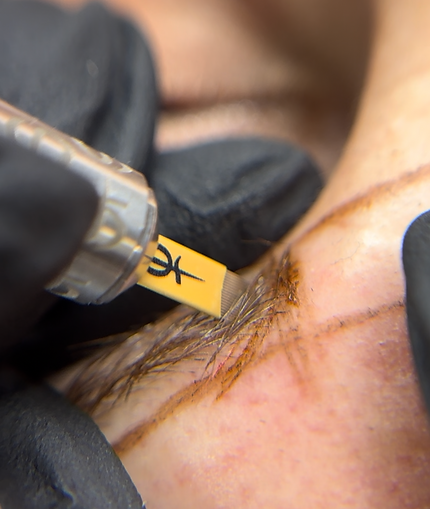 Close-up view of a microblading tool on a clean surface