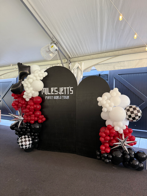 Miles Jetts First World Tour black heart shape with balloons decoration.