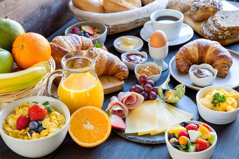 breakfast table full of fruit, grains, and proteins