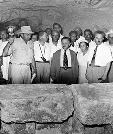 The Eleventh Convention of Land of Israel Studies, Kiryat Tivon, 1955. Nahman Avigad explains the finds in a burial cave at Beth Shearim to Moshe Sharett and Yosef Sprinzak
