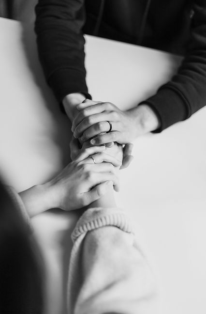 person in black long sleeve shirt holding babys feet_edited.jpg
