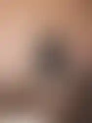 Detailed back view of the avant-garde dress featuring hand-pleated liquid-look organza.