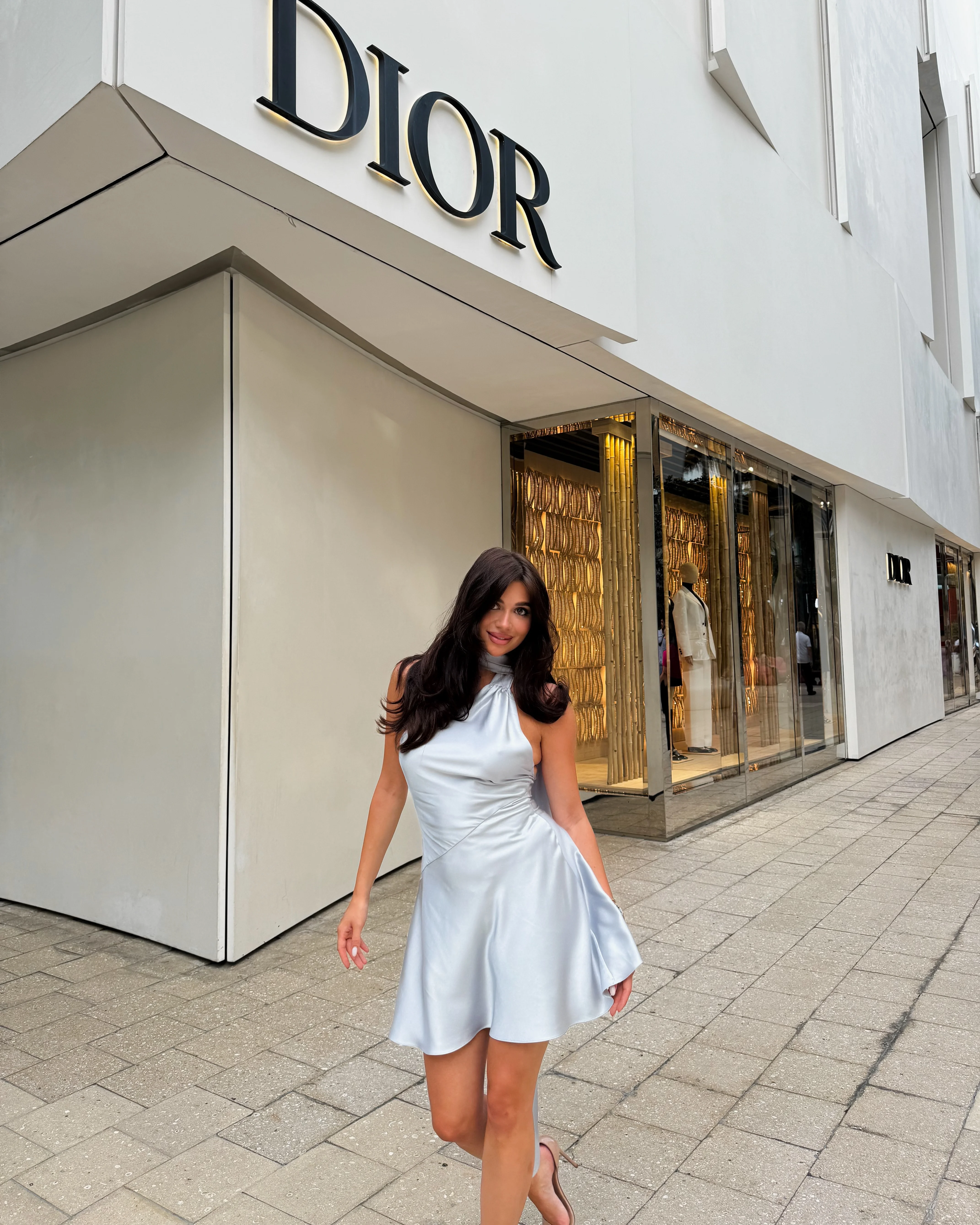 Luxury vacation in Europe outfit idea satin halter neck mini dress Bree evening look