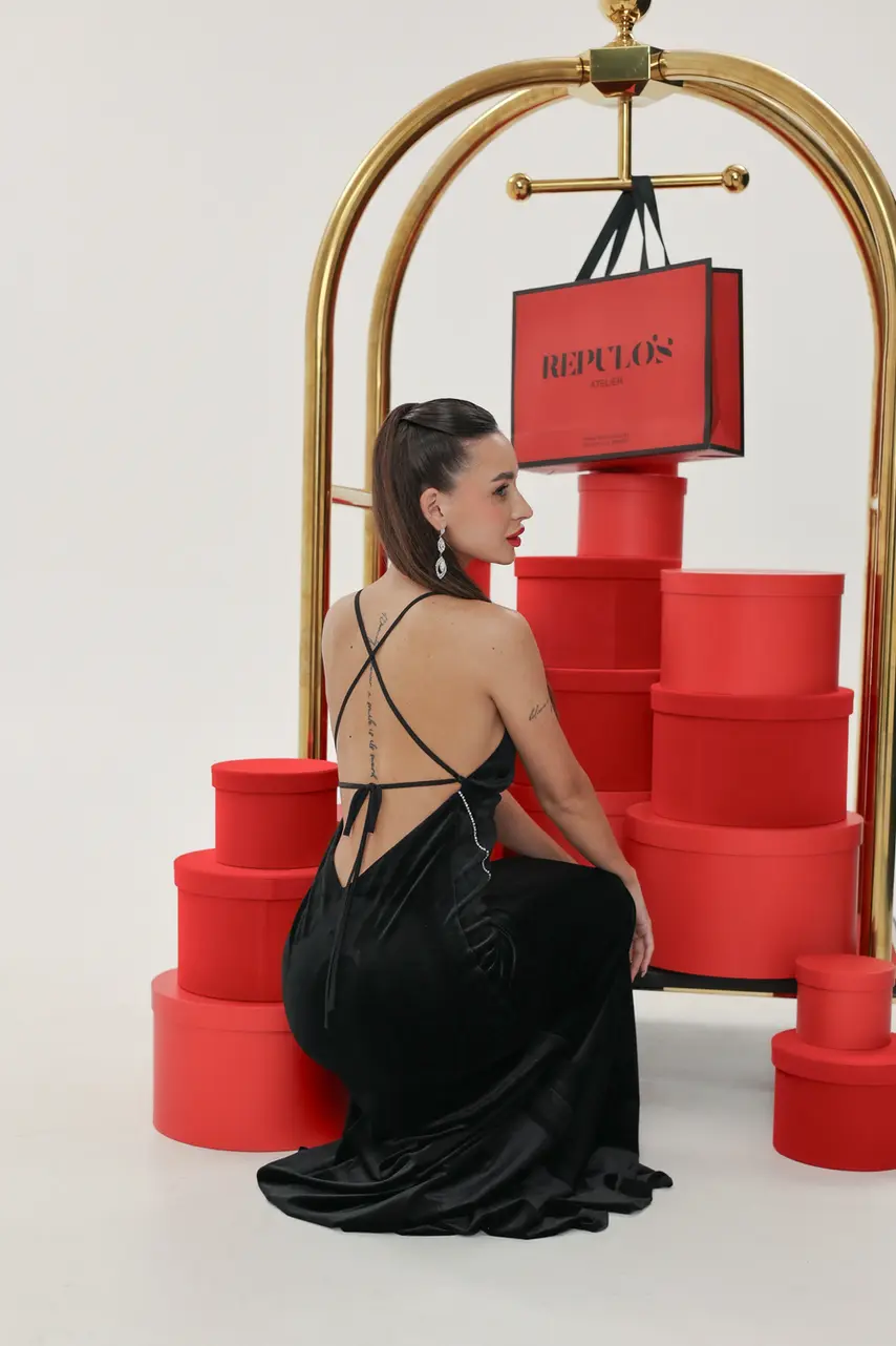 Back view of black velour backless gown with thin straps