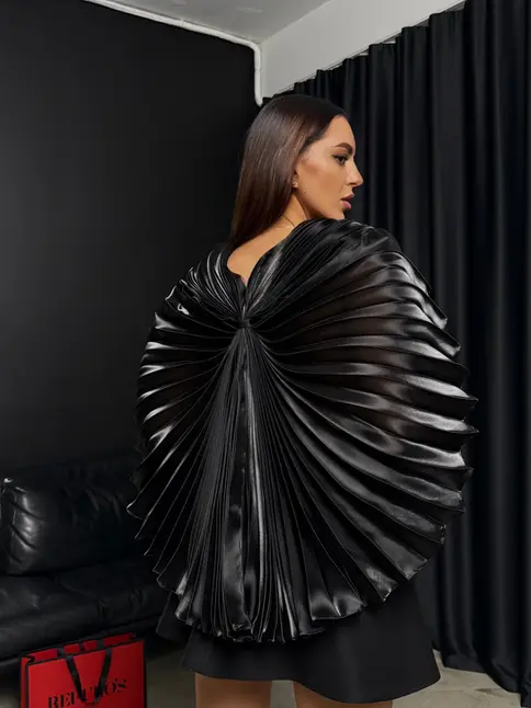 Avant-garde dress by REPULO'S with butterfly-like structural wings spread out.