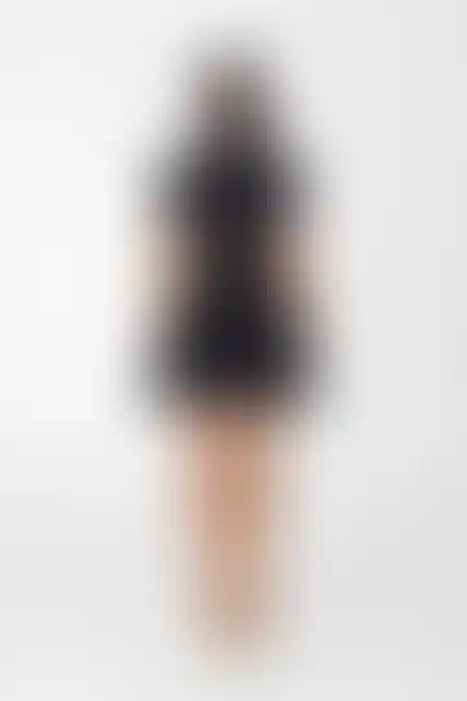 Model wearing mini cape over dress for layered look back view