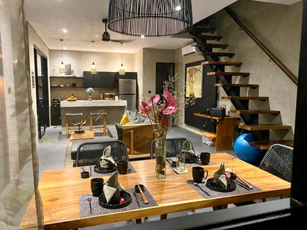 Zen Villa in Canggu: A serene oasis with a spacious living room, kitchen area adorned in earthy, natural colors, and modern wooden furniture.