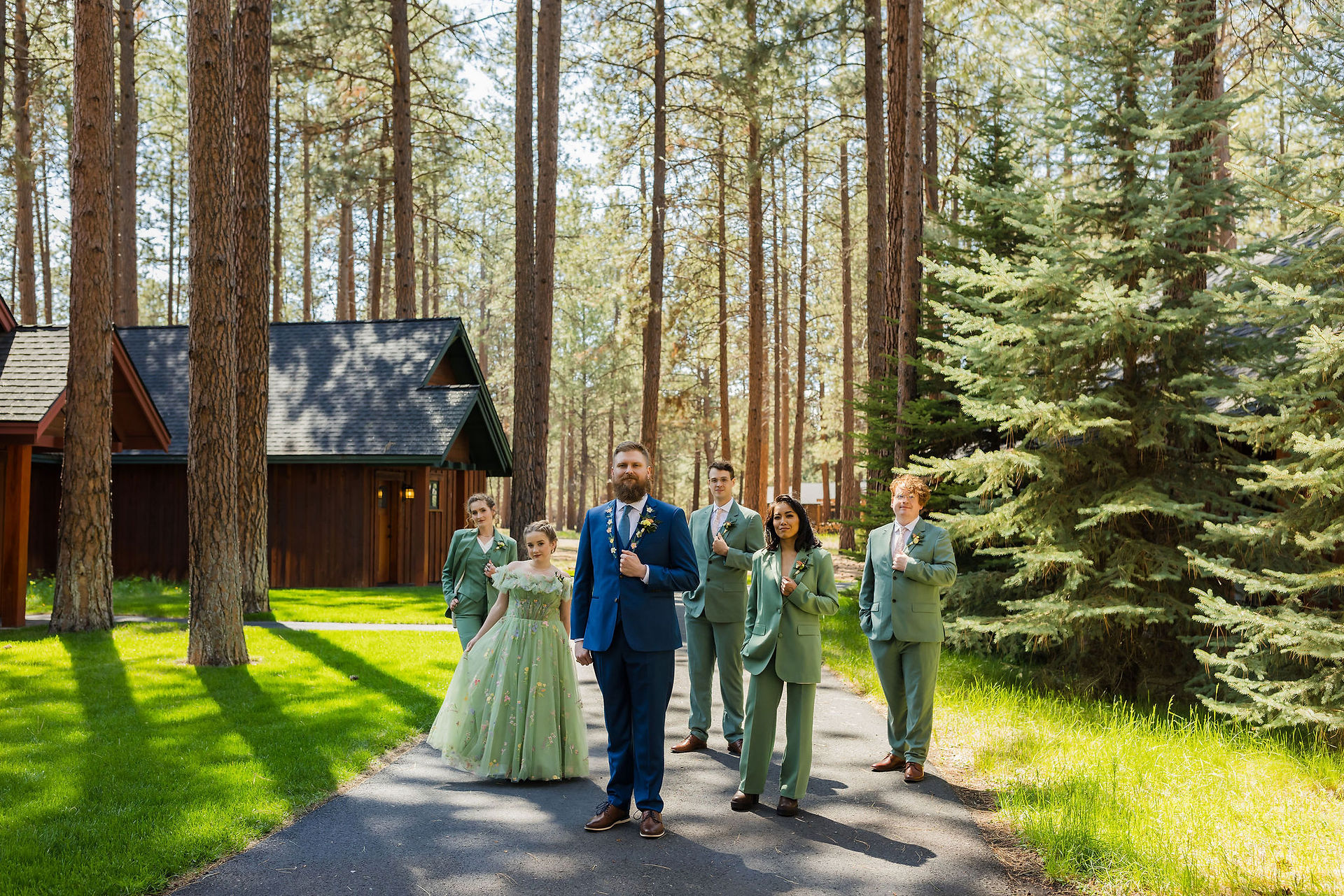Groom in blue suit, groom's party wearing green suits at FivePine Lodge wedding venue in Sisters, OR