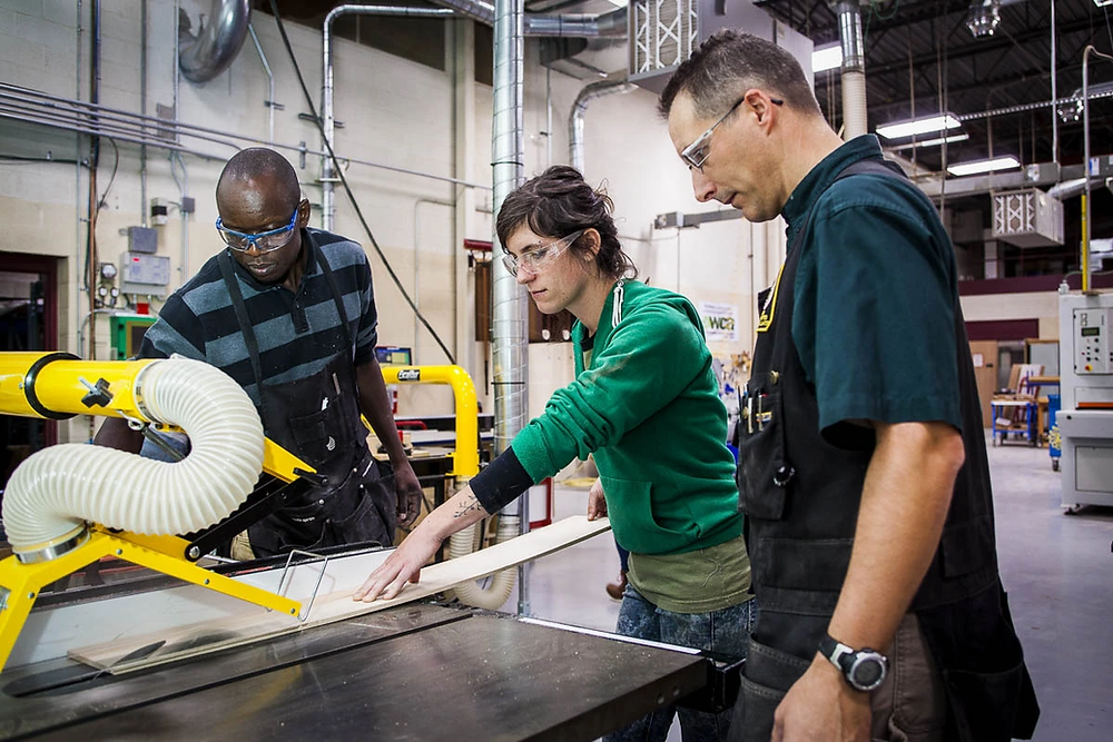 Cabinetmaking and Millwork Program Director Patrick Molzahn with students Lauren and Felix.