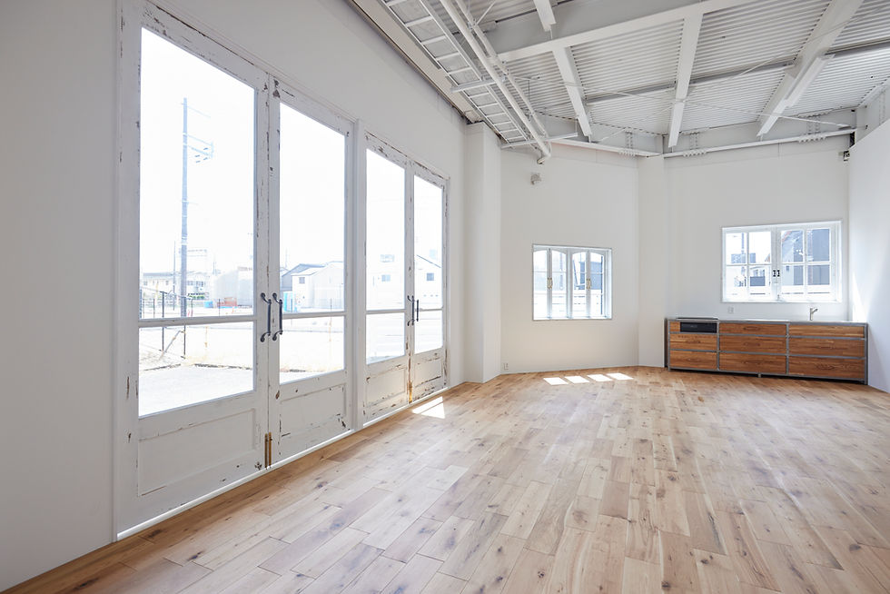 Eye-level view of a professional photography studio with natural light and camera equipment