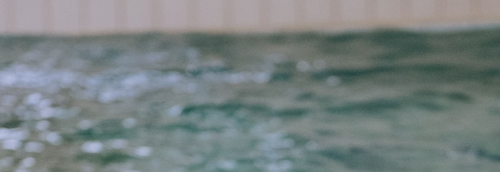 Three kids are splashing in an indoor swimming pool_edited.jpg