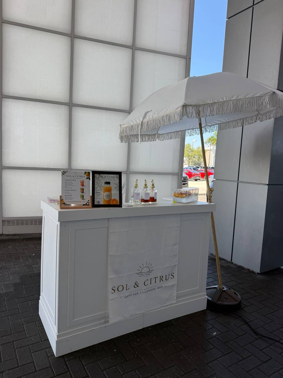 Sol & Citrus mobile beverage bar in Miami with umbrella.