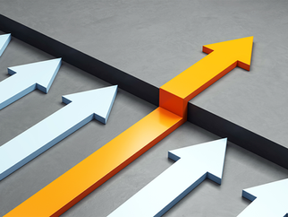 Yellow arrow breaking through a barrier among white arrows on a gray surface, symbolizing leadership and innovation.