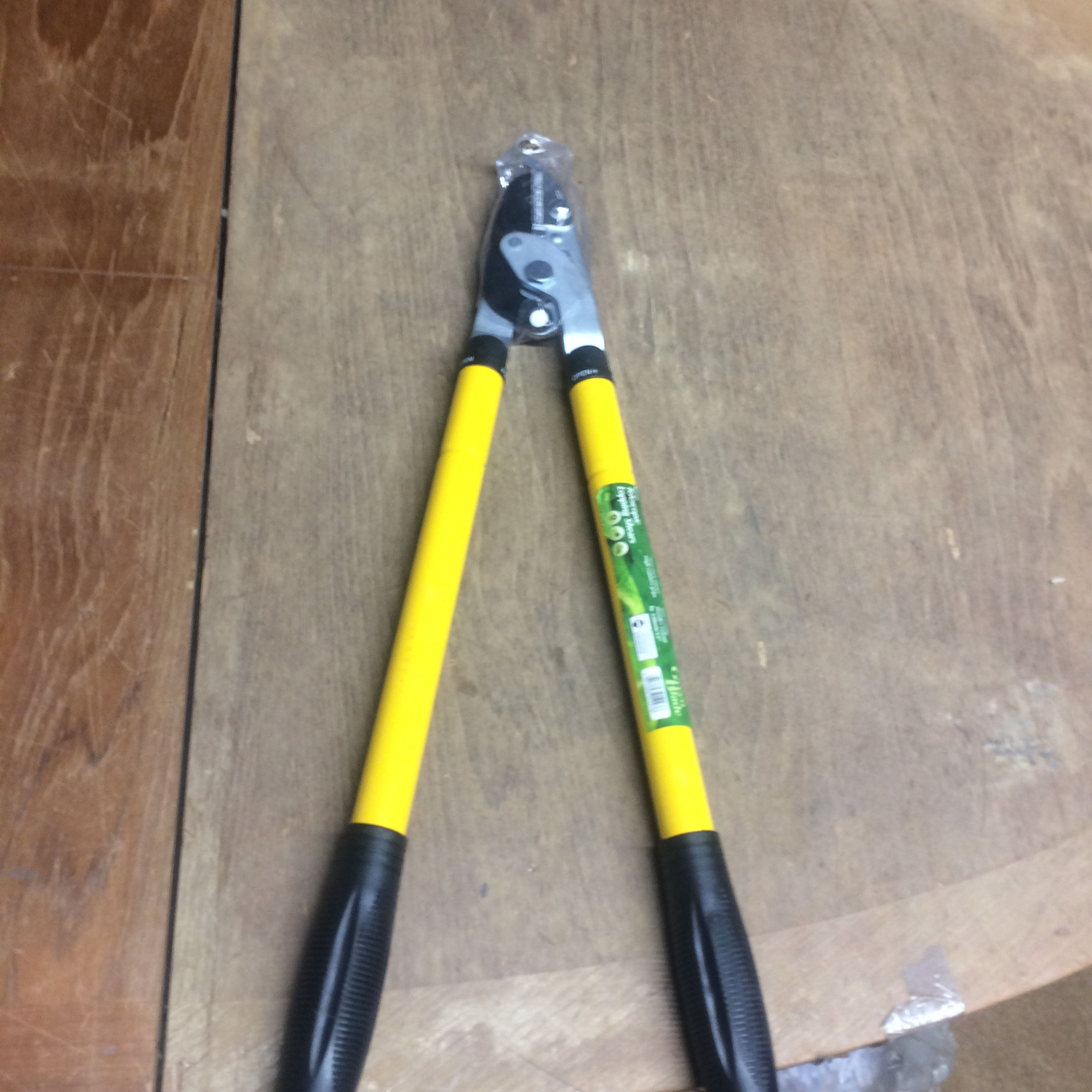 Yellow-handled garden shears on wood table
