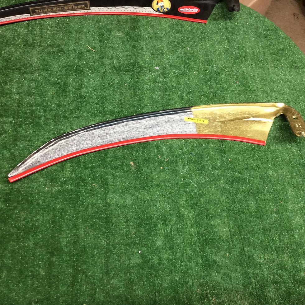 A curved gold and black scythe blade