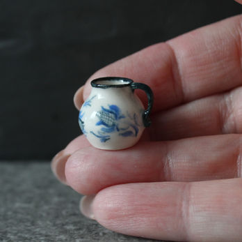White miniature ceramic jug with blue flowers and leaves