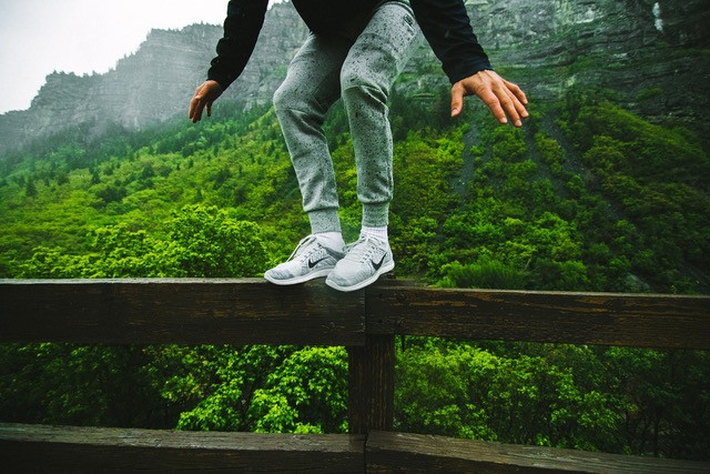 man standing on fence, balancing