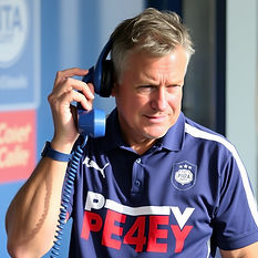 Sports coach wearing blue on the telephone with the wording PE4EY on their shirt.jpg