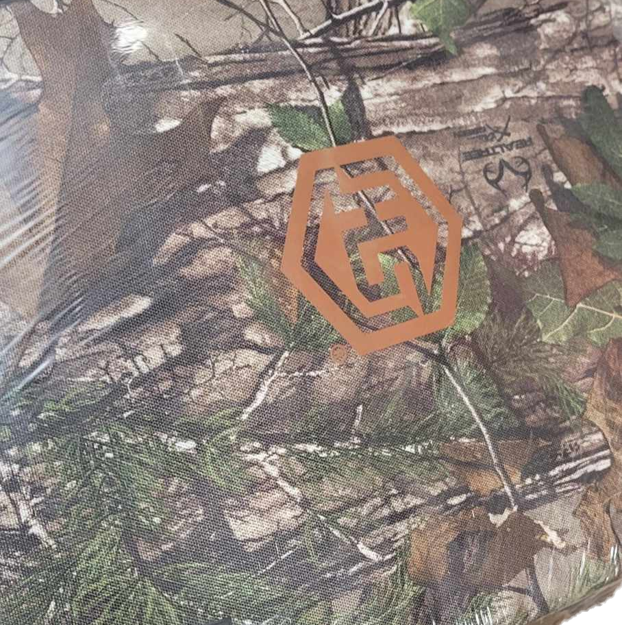 Orange hexagonal logo on camouflage pattern