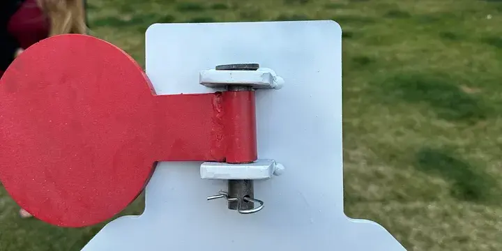 Red circular metal shooting target on a stand