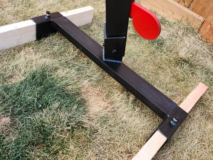 Thumbnail: Metal shooting target stand base with red target on grass