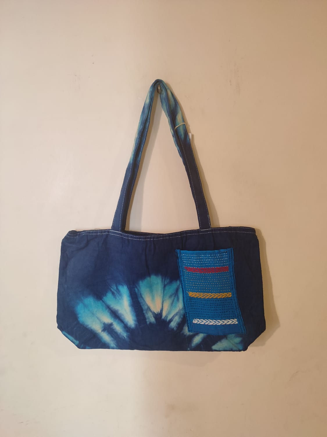Bag: Blue cotton tie-dye bag with Kantha-embroidered pocket