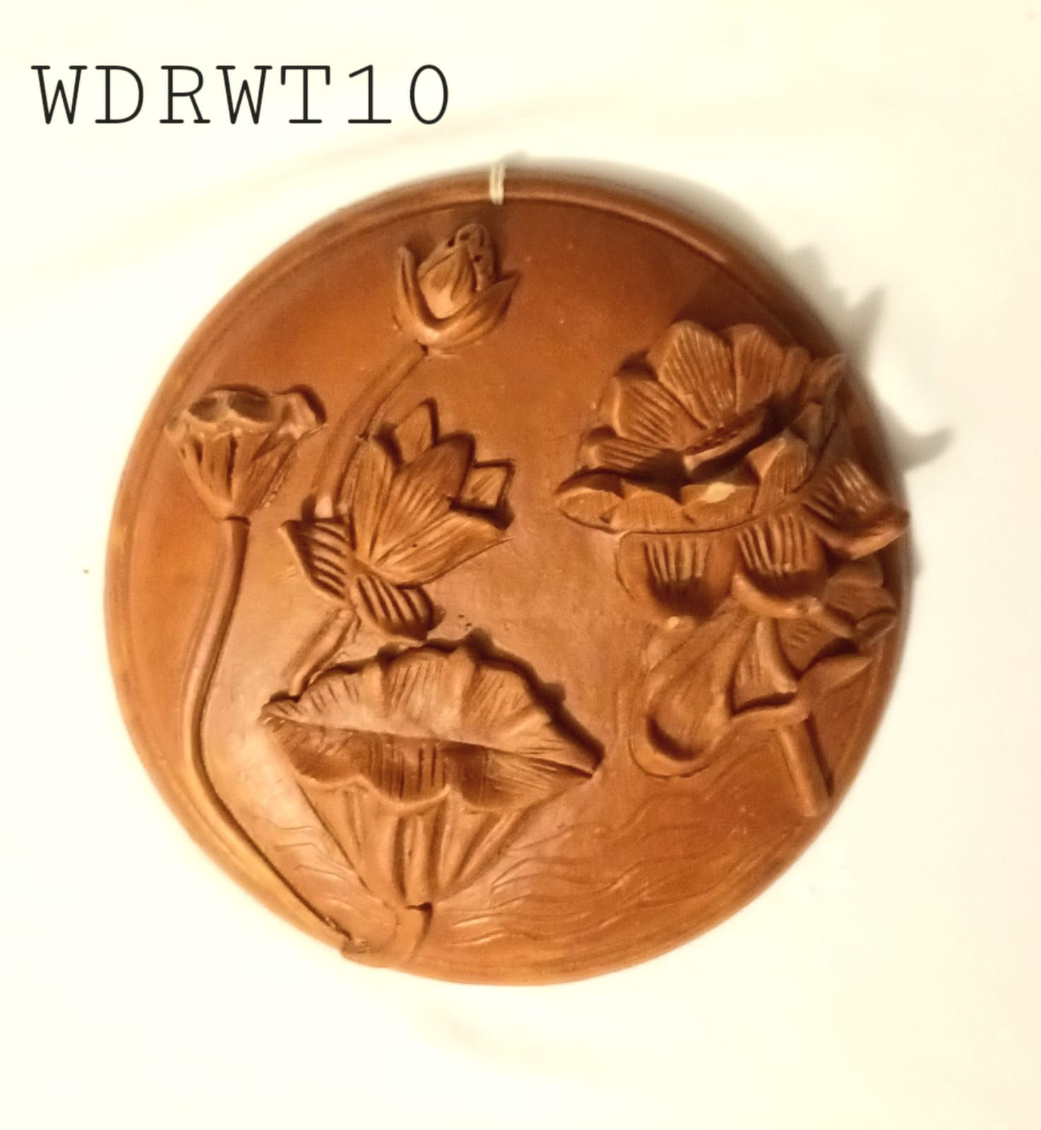 Wall Decor: Flower motif as relief work in terracotta
