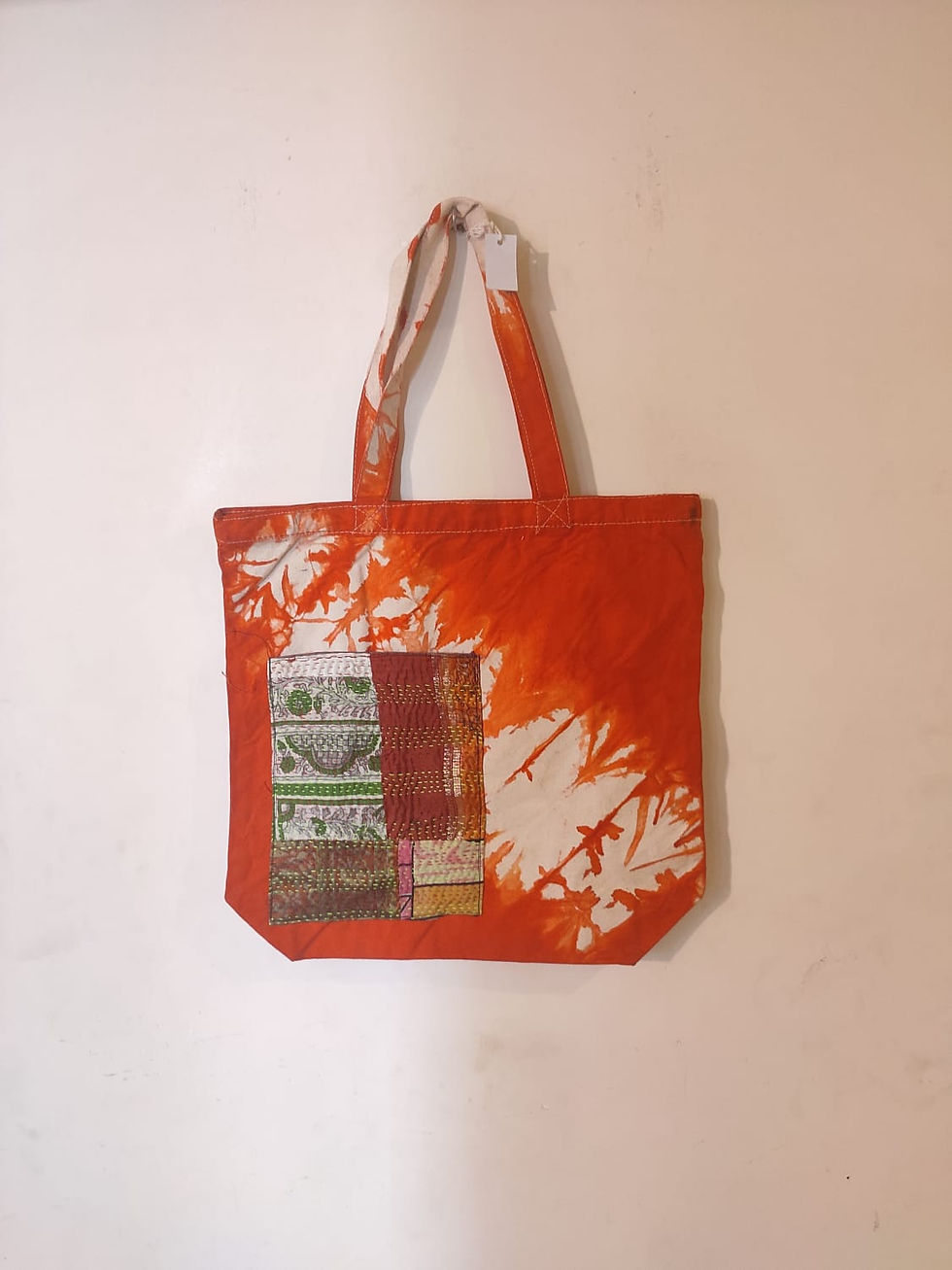 Bag: Orange cotton tie-dye bag with Kantha-embroidered pocket