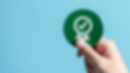 hand holding paper with certificate icon