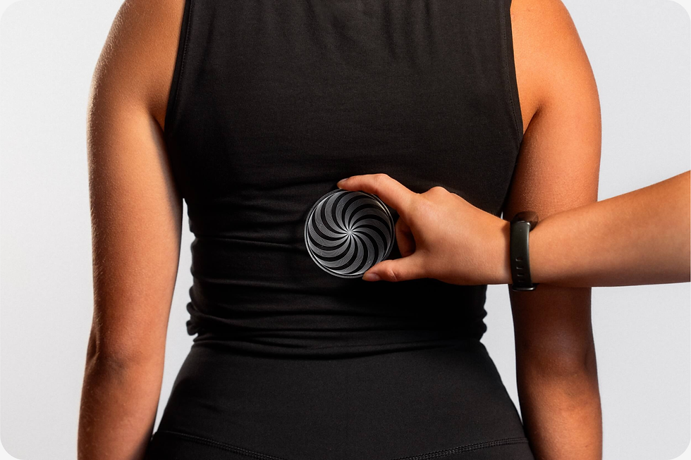 A person in a black top has a Vortice disc on their back. Soft white background.