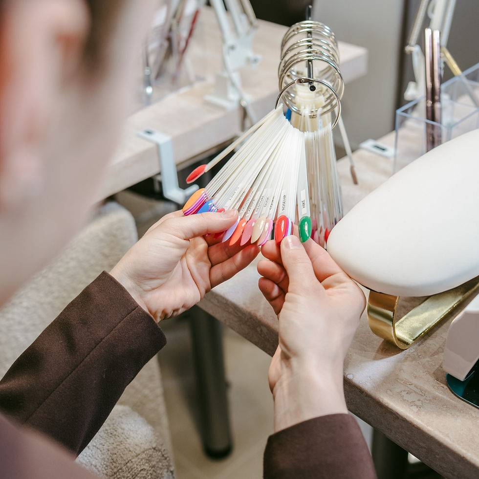 Lady choosing the best colour for her nails in the modern salon in the centre of Prague for her manicure and pedicure.