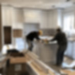 construction-workers-installing-new-cabinets-appliances-full-kitchen-renovation.jpg
